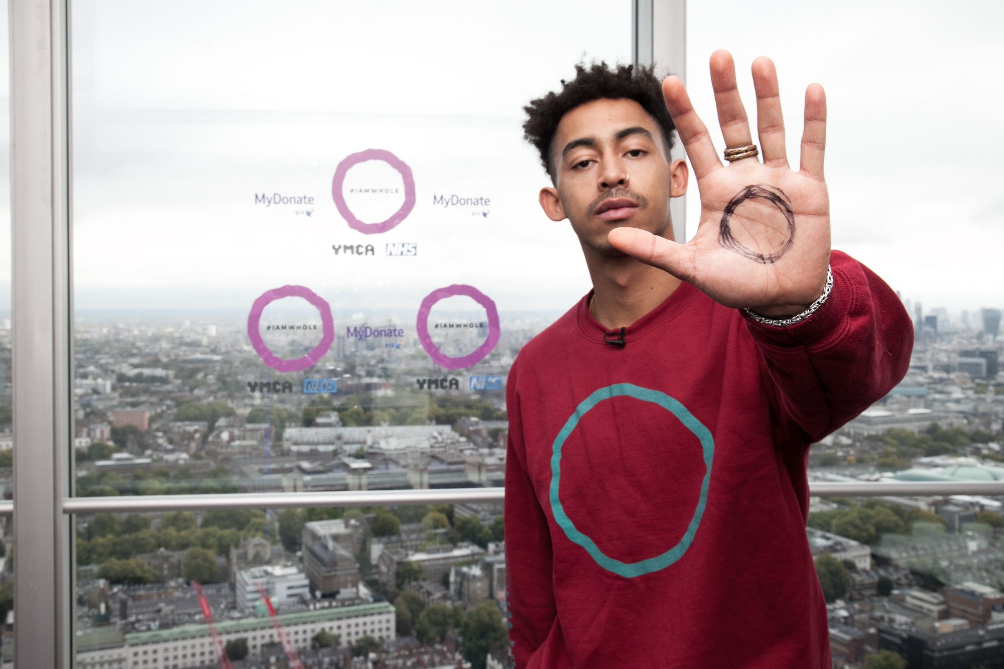 Jordan Stephens of Rizzle Kicks with the #IAMWHOLE circle